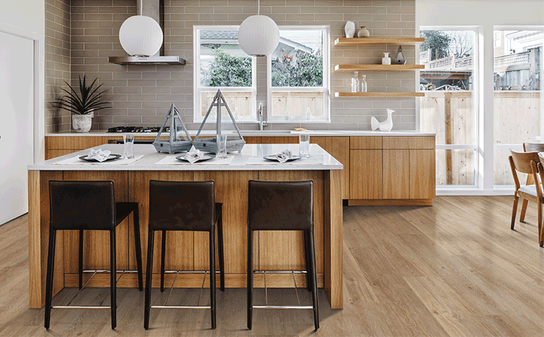 luxury vinyl plank flooring in kitchen with warm wood cabinetry
